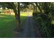 Gravel driveway leading to a home, lined with lush greenery at 6155 Bethlehem Rd, Mulberry, FL 33860