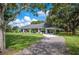 Charming single-story home with a well-manicured lawn, covered porch, and a spacious driveway at 6155 Bethlehem Rd, Mulberry, FL 33860