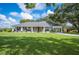 Inviting single-story home boasts a covered front porch, vibrant landscaping, and a convenient carport at 6155 Bethlehem Rd, Mulberry, FL 33860
