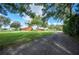 Farm with several buildings, including a red barn, visible from a long driveway at 6155 Bethlehem Rd, Mulberry, FL 33860