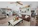 Spacious living room features a ceiling fan, wood-look flooring, and seamless access to the dining area at 6155 Bethlehem Rd, Mulberry, FL 33860