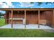 Rustic outdoor kitchen features stainless steel counters, wooden beams, and a charming wooden bench at 6155 Bethlehem Rd, Mulberry, FL 33860