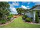 Lush landscaped yard showcasing meticulous gardening and a charming bench seating area at 6155 Bethlehem Rd, Mulberry, FL 33860