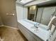 Well-lit bathroom featuring a large mirror, extended vanity, and ceramic tile floors at 6718 Trail Ridge Dr, Lakeland, FL 33813