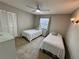 Cozy bedroom featuring two twin beds, a ceiling fan, and a closet for storage at 6718 Trail Ridge Dr, Lakeland, FL 33813