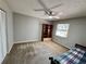 Spacious bedroom with a ceiling fan and neutral walls and carpet at 6718 Trail Ridge Dr, Lakeland, FL 33813