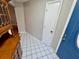 Inviting entryway with classic tile flooring and blue front door at 6718 Trail Ridge Dr, Lakeland, FL 33813