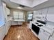 Bright kitchen featuring white cabinets, laminate floors, and a breakfast nook under a skylight at 6718 Trail Ridge Dr, Lakeland, FL 33813