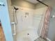 Modern tiled shower featuring a shower head with assistive hand rail at 6718 Trail Ridge Dr, Lakeland, FL 33813