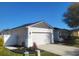 Well-maintained house featuring a spacious two-car garage and tidy landscaping in a suburban neighborhood at 6799 Glenbrook Dr, Lakeland, FL 33811