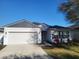 Inviting one-story home with a tidy yard, two-car garage, and a cozy entrance for suburban living at 6799 Glenbrook Dr, Lakeland, FL 33811
