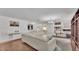 Bright living room with hardwood floors, a large white sectional, and modern decor at 6799 Glenbrook Dr, Lakeland, FL 33811
