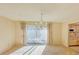 Elegant dining room features a chandelier and sliding glass doors at 718 Barber Cir # 718, Lakeland, FL 33803