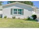 Side view of a white house with sliding glass door and a small patio at 718 Barber Cir # 718, Lakeland, FL 33803