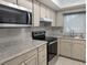 Bright kitchen features granite countertops and stainless steel appliances at 718 Barber Cir # 718, Lakeland, FL 33803