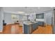 Open concept kitchen with island, hardwood floors, and stainless steel appliances at 2325 Bella Luna Cir, Lakeland, FL 33810