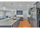 Modern kitchen with gray cabinets, quartz countertops, and stainless steel appliances at 2325 Bella Luna Cir, Lakeland, FL 33810