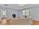 Light-filled living room with neutral colored couch and hardwood floors at 2325 Bella Luna Cir, Lakeland, FL 33810