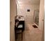 A bright bathroom features double sinks, granite countertop, tiled floors and a glass enclosed shower at 3136 Country Club Cir, Winter Haven, FL 33881