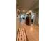 Hallway with tile floor leading to a bedroom and living room with an ornate wood console table at 3136 Country Club Cir, Winter Haven, FL 33881