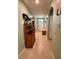Inviting hallway with neutral walls, tile floors, decorative niche, and a view of the front door at 3136 Country Club Cir, Winter Haven, FL 33881