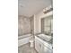 Bathroom featuring a shower-tub combo with tile and a vanity with granite top at 4050 Tullamore Ln, Auburndale, FL 33823