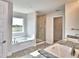 Bright bathroom features a large window over the tub and a glass shower at 4050 Tullamore Ln, Auburndale, FL 33823
