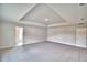Large carpeted bedroom with neutral walls, tray ceiling, and a doorway at 4050 Tullamore Ln, Auburndale, FL 33823