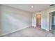 Spacious bedroom with neutral walls and carpeting, a large window and walk-in closet at 4050 Tullamore Ln, Auburndale, FL 33823