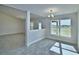 The dining area features tile floors and a view to the outdoors through a large window at 4050 Tullamore Ln, Auburndale, FL 33823