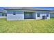 Backyard view of the home with a covered patio and lush green lawn at 4639 Grandview Glen Dr, Auburndale, FL 33823