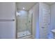 Bathroom with glass enclosed shower featuring tile walls, shower head, and white door at 4639 Grandview Glen Dr, Auburndale, FL 33823