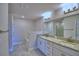 Bathroom featuring double vanity with granite countertops, tub, and separate shower with glass door at 4639 Grandview Glen Dr, Auburndale, FL 33823