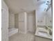 Bright bathroom featuring a double sink vanity with granite counters and tiled bathtub with shower at 4639 Grandview Glen Dr, Auburndale, FL 33823