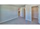 Carpeted bedroom featuring a walk-in closet and an open doorway to the kitchen at 4639 Grandview Glen Dr, Auburndale, FL 33823