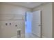 Functional laundry room with overhead shelving and tile flooring at 4639 Grandview Glen Dr, Auburndale, FL 33823