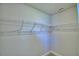 Spacious walk-in closet with installed shelving and neutral colored walls and carpet at 4639 Grandview Glen Dr, Auburndale, FL 33823