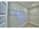Walk-in closet with neutral walls, carpet, and metal shelving for ample storage space at 4639 Grandview Glen Dr, Auburndale, FL 33823