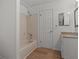 Clean bathroom with beige tile, bathtub, and updated vanity at 6123 Topher Trl # 63C, Mulberry, FL 33860