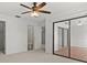 Spacious bedroom with ceiling fan and access to a sunroom at 6123 Topher Trl # 63C, Mulberry, FL 33860