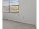 Bedroom with large window, neutral walls, and carpet flooring at 6123 Topher Trl # 63C, Mulberry, FL 33860