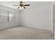 Bright bedroom with neutral carpeting and a ceiling fan at 6123 Topher Trl # 63C, Mulberry, FL 33860