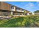 Rear view of condo building showcasing green space at 6123 Topher Trl # 63C, Mulberry, FL 33860