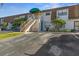 Front view of condo building with stairs and parking at 6123 Topher Trl # 63C, Mulberry, FL 33860