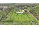Overhead view of sprawling property with a home, pond, outbuildings, and wooded surroundings at 9240 Moore Rd, Lakeland, FL 33809