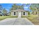 Newly constructed home with a green exterior, white trim, and a spacious yard at 110 5Th Sw St, Fort Meade, FL 33841