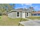 Newly built home with green exterior, white trim, and a concrete driveway at 110 5Th Sw St, Fort Meade, FL 33841