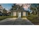Newly constructed home with a green exterior, white trim, and a spacious yard at 110 5Th Sw St, Fort Meade, FL 33841