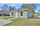 Newly built home with green exterior, white trim, and a concrete driveway at 110 5Th Sw St, Fort Meade, FL 33841
