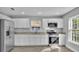 Modern kitchen with white cabinets, stainless steel appliances, and granite countertops at 110 5Th Sw St, Fort Meade, FL 33841